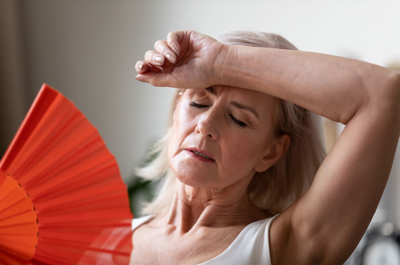 woman fanning her face to relive stress