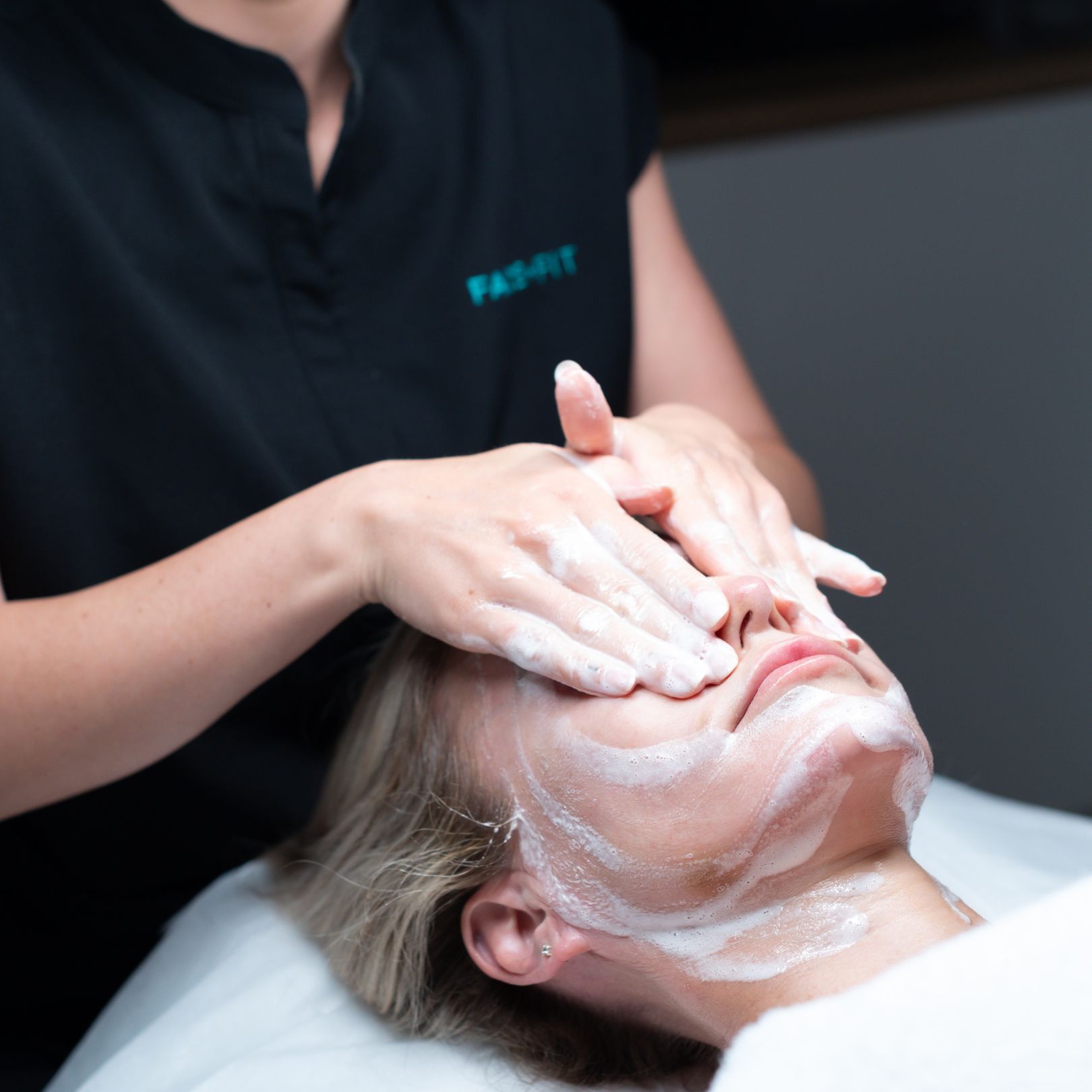 Face Fit Therapist performing facial massage on woman patient