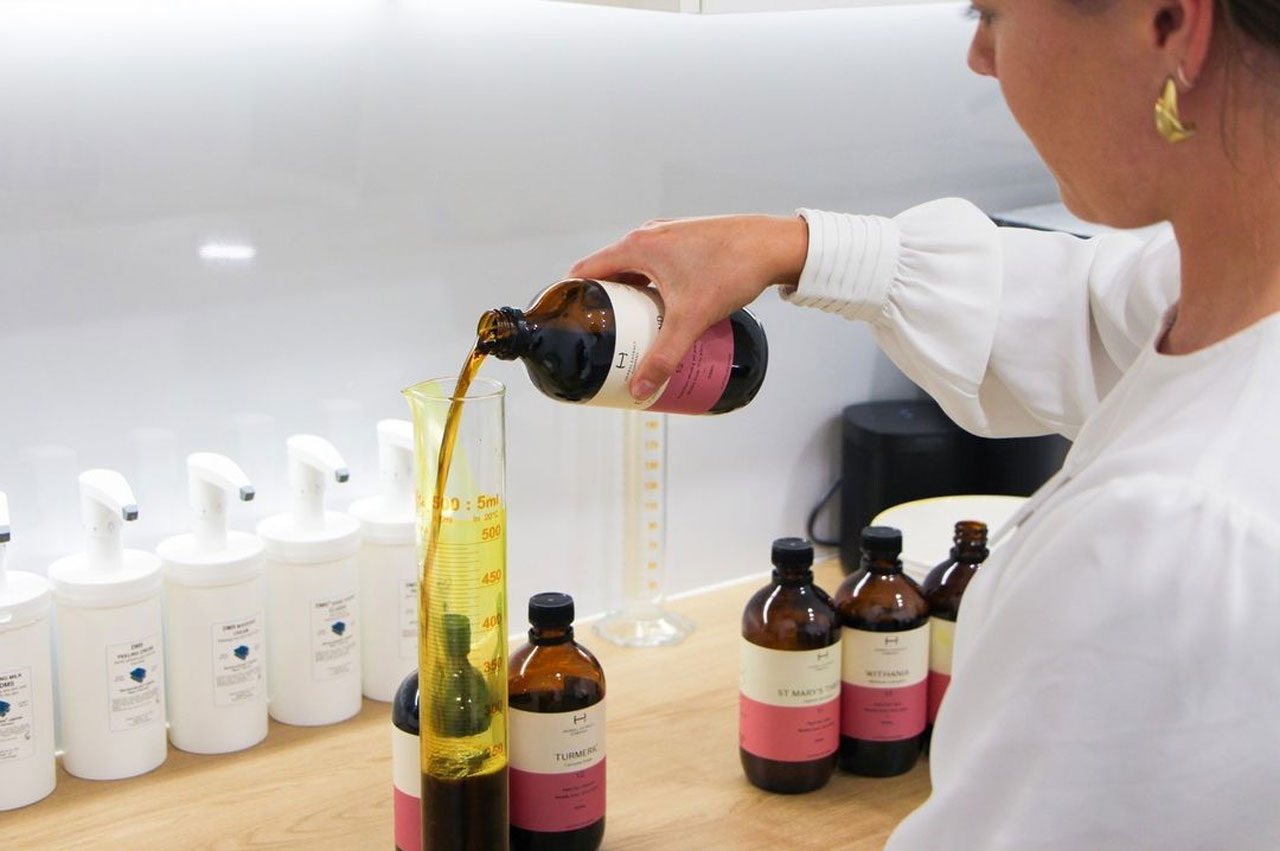 Face Fit's naturopath preparing a tonic for patient